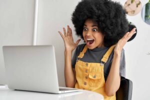 excited-african-woman-looking-at-laptop-winning-on-2021-09-02-07-16-22-utc-scaled-1.jpg